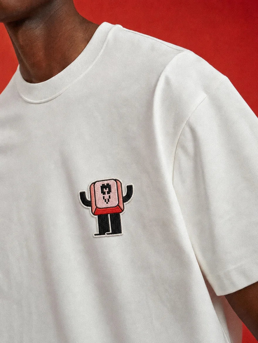 White tee with a small Rekko mascot on the chest